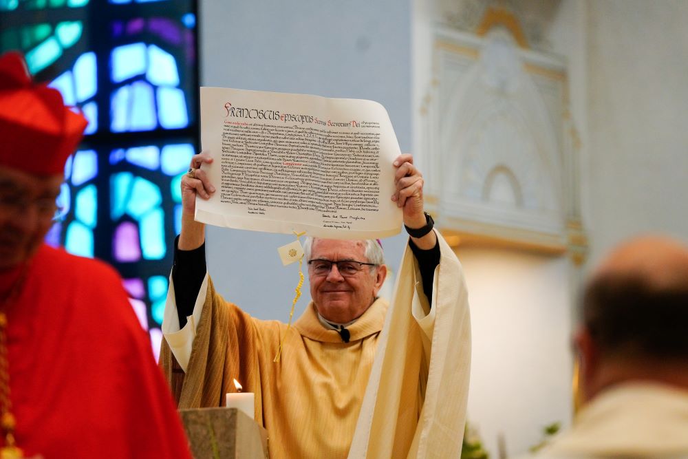 Archbishop George Thomas of Las Vegas processes through the Shrine of the Most Holy Redeemer in Las Vegas with the papal bull from Pope Francis during a Mass.
